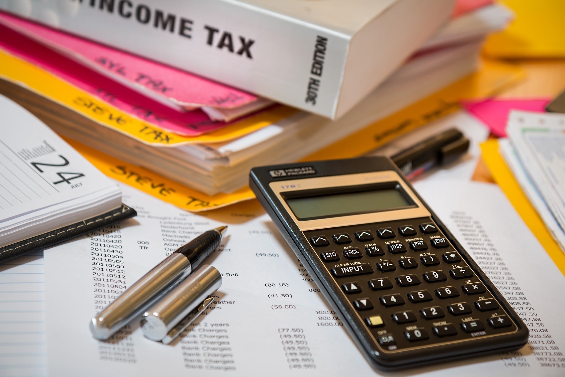 Income tax paperwork with calculator and pen