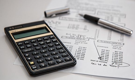 Calculator and pen on financial documents