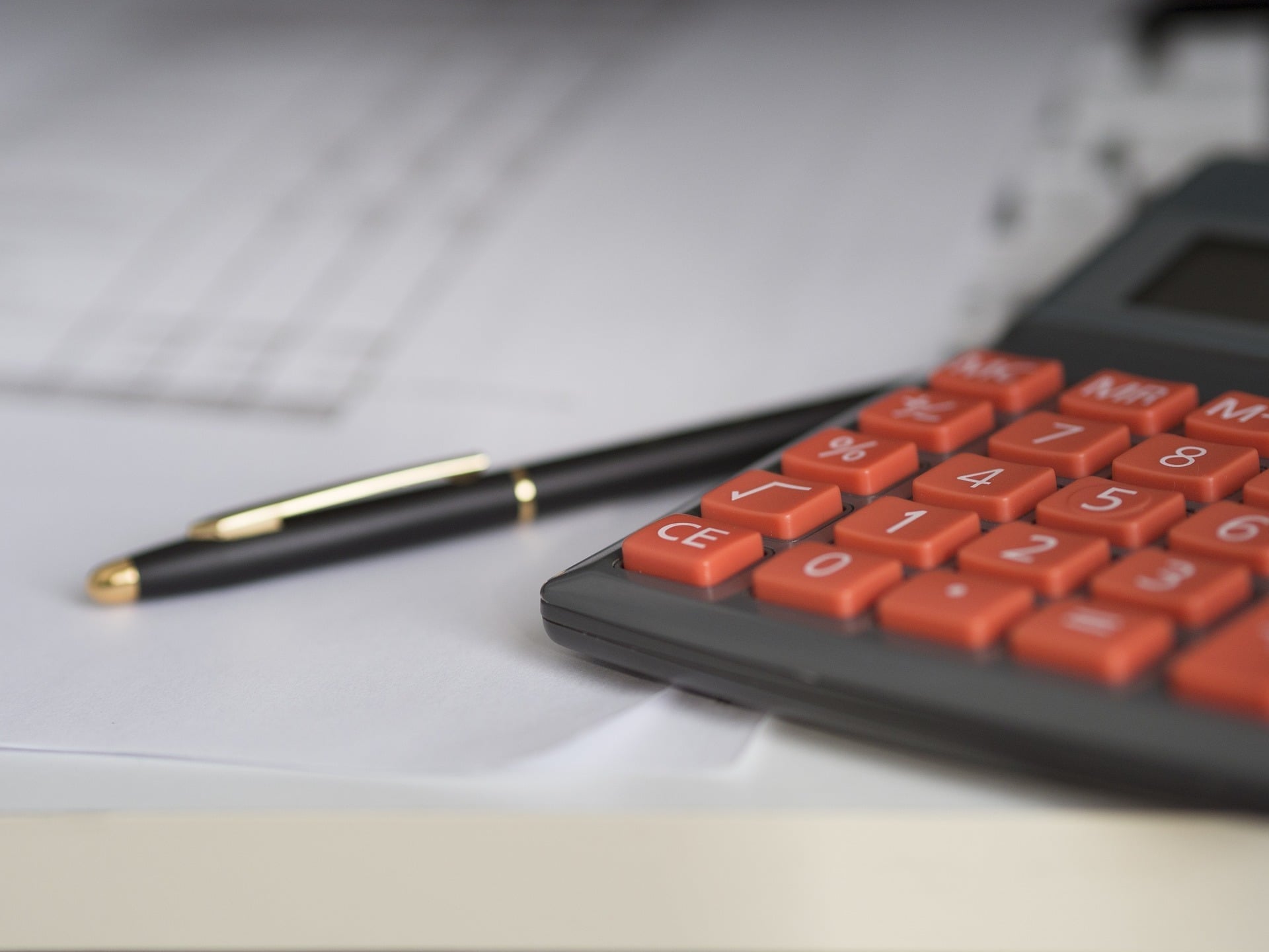 Calculator and pen on financial paperwork