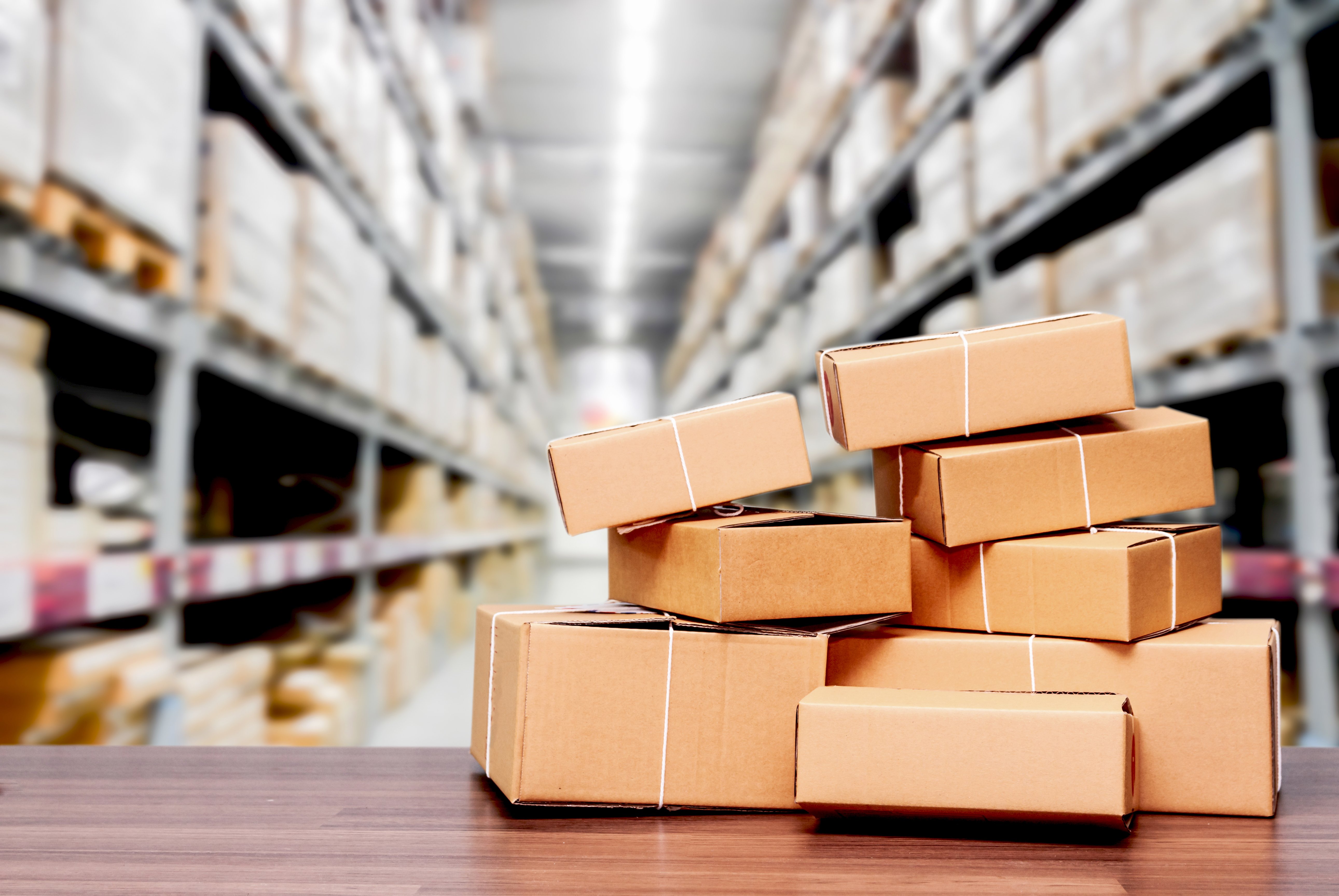 Stacked cardboard boxes in warehouse aisle