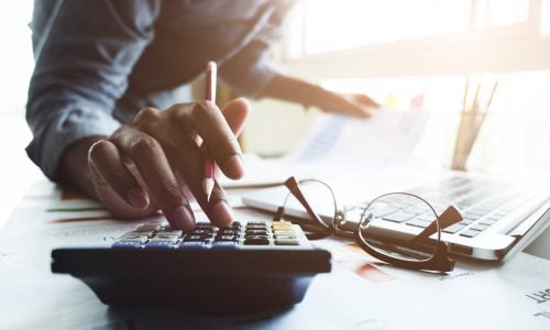 Close,Up,Of,Businessman,Or,Accountant,Hand,Holding,Pen,Working
