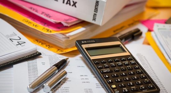 Income tax paperwork with calculator and pen