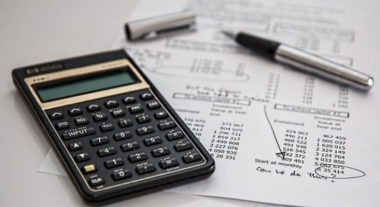 Calculator and pen on financial documents